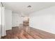 Spacious living room featuring wood-look flooring and views of the open kitchen at 848 Hedge Way # 5, Las Vegas, NV 89110