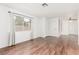 Bright living room featuring wood-look flooring, fresh paint, and ample natural light at 848 Hedge Way # 5, Las Vegas, NV 89110