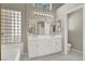 Bathroom with a double sink vanity, glass block window, and tile flooring at 8612 Chiquita Dr, Las Vegas, NV 89128
