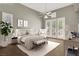Bright bedroom featuring a ceiling fan, french doors, a sitting area, and neutral decor at 8612 Chiquita Dr, Las Vegas, NV 89128