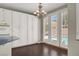 Bright dining area with white cabinets, a chandelier, and a view to the pool at 8612 Chiquita Dr, Las Vegas, NV 89128