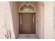 The front entry showcases a custom front door with sidelights and decorative transom window at 8612 Chiquita Dr, Las Vegas, NV 89128