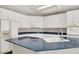 Spacious kitchen featuring ample white cabinetry and modern stainless appliances at 8612 Chiquita Dr, Las Vegas, NV 89128
