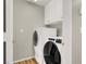 Bright laundry room with front loading washer and dryer and white cabinets at 8612 Chiquita Dr, Las Vegas, NV 89128