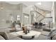 A spacious living room showcases an open-concept floorplan with stairs and dining space at 8612 Chiquita Dr, Las Vegas, NV 89128