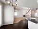 Open concept living space leading from the kitchen to the living room with fireplace and staircase at 8612 Chiquita Dr, Las Vegas, NV 89128