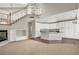 Bright, open living space with staircase, fireplace, and flows into the modern kitchen at 8612 Chiquita Dr, Las Vegas, NV 89128