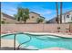 Sparkling pool with clear blue water and a partial view of neighboring homes and fencing at 8612 Chiquita Dr, Las Vegas, NV 89128