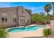 Backyard oasis features a sparkling pool, lush landscaping, and a beautiful home exterior at 8612 Chiquita Dr, Las Vegas, NV 89128