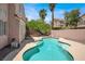 Backyard with inviting pool, lush greenery, and a glimpse of the house exterior at 8612 Chiquita Dr, Las Vegas, NV 89128