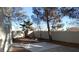 View of backyard with block wall, trees and shrubs at 9709 Port Orange Ln, Las Vegas, NV 89134
