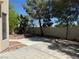 Spacious backyard features a concrete patio, mature trees, and landscaped areas at 9709 Port Orange Ln, Las Vegas, NV 89134