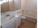 Bathroom vanity featuring single sink, white cabinets, tile flooring and soaking tub at 9709 Port Orange Ln, Las Vegas, NV 89134