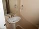 Half bathroom with pedestal sink and decorative mirror at 9709 Port Orange Ln, Las Vegas, NV 89134