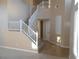 Bright foyer featuring tile flooring and staircase leading to the upper level at 9709 Port Orange Ln, Las Vegas, NV 89134