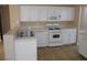 Functional kitchen with white cabinets and tiled countertops, equipped with modern appliances at 9709 Port Orange Ln, Las Vegas, NV 89134