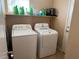 Bright laundry room features modern washer, dryer, and shelf at 9709 Port Orange Ln, Las Vegas, NV 89134