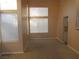 Bright living room with large windows and neutral carpet at 9709 Port Orange Ln, Las Vegas, NV 89134