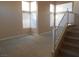 Living room with multiple windows providing ample natural light and neutral carpet at 9709 Port Orange Ln, Las Vegas, NV 89134