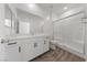 Bathroom featuring a shower, a toilet, a mirror, and modern white cabinetry at 9839 Berkley Brook Ct, Las Vegas, NV 89141