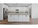 Spacious kitchen features a large center island with a grey countertop, stainless steel appliances, and white cabinetry at 9839 Berkley Brook Ct, Las Vegas, NV 89141
