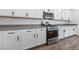 Modern kitchen with stainless steel oven, range, microwave, white cabinetry, and a grey countertop at 9839 Berkley Brook Ct, Las Vegas, NV 89141