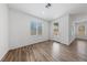Bright living room features wood flooring, a window, and a glass door leading to the backyard at 9839 Berkley Brook Ct, Las Vegas, NV 89141