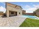 Inviting backyard pool and spa, perfect for relaxation and entertaining with a paved deck and privacy fence at 9839 Berkley Brook Ct, Las Vegas, NV 89141