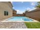 Inviting backyard pool and spa, perfect for relaxation and entertaining with a paved deck and privacy fence at 9839 Berkley Brook Ct, Las Vegas, NV 89141