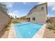 Inviting backyard pool and spa, perfect for relaxation and entertaining with a paved deck and privacy fence at 9839 Berkley Brook Ct, Las Vegas, NV 89141