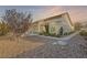 Attractive single-story house with desert landscaping, a Spanish tile roof, and wrought iron fencing at 9920 Netherton Dr, Las Vegas, NV 89134