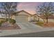 Charming single-story home with a Spanish tile roof, two-car garage, and desert landscaping at 9920 Netherton Dr, Las Vegas, NV 89134