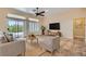 Bright living room with comfortable seating, a sliding door to the backyard, and lots of natural light at 9920 Netherton Dr, Las Vegas, NV 89134