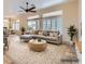 Spacious living room with comfortable seating, a large rug, and big windows, perfect for relaxing or entertaining at 9920 Netherton Dr, Las Vegas, NV 89134