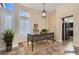 Bright office space with large windows, a wooden desk, and tiled floors, ideal for remote work at 9920 Netherton Dr, Las Vegas, NV 89134