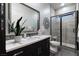 A bathroom features modern fixtures, a glass-enclosed shower, and a stylish vanity with a large mirror at , Las Vegas, NV 89135