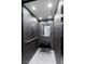 The modern elevator features mosaic tile walls, a bench, and a reflective mirror at , Las Vegas, NV 89135