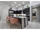 Contemporary kitchen features a waterfall island, black cabinetry and stylish lighting at , Las Vegas, NV 89135