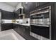 Close up of a sleek kitchen with stainless steel appliances and dark wood cabinets at , Las Vegas, NV 89135