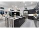 Open concept kitchen with waterfall island, pendant lights and seamless flow to living area at , Las Vegas, NV 89135