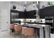 Modern kitchen showcasing a waterfall island, black cabinets and stainless appliances at , Las Vegas, NV 89135