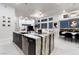 Open concept kitchen with a waterfall island, bar seating and stainless appliances at , Las Vegas, NV 89135