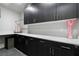Laundry room features dark wood cabinets, light countertop, decor, and hanging rack at , Las Vegas, NV 89135
