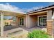 The charming covered patio area features desert landscaping, brick accents, and stucco exterior at 10182 Skye Run Ave, Las Vegas, NV 89166