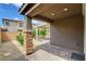 Covered patio with stacked stone columns, brick pavers, and desert landscaping at 10182 Skye Run Ave, Las Vegas, NV 89166