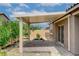 The covered patio has desert landscaping, brick accents, and stucco exterior at 10182 Skye Run Ave, Las Vegas, NV 89166