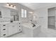 Elegant bathroom with soaking tub, dual vanities, and walk-in closet at 10182 Skye Run Ave, Las Vegas, NV 89166