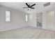 Spacious bedroom featuring carpet, ceiling fan, and ensuite bathroom access at 10182 Skye Run Ave, Las Vegas, NV 89166