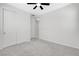Bedroom features neutral carpet, a ceiling fan, and a double door closet at 10182 Skye Run Ave, Las Vegas, NV 89166
