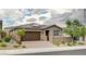 Inviting single-story home with desert landscaping, a tile roof, solar panels, and a two-car garage at 10182 Skye Run Ave, Las Vegas, NV 89166